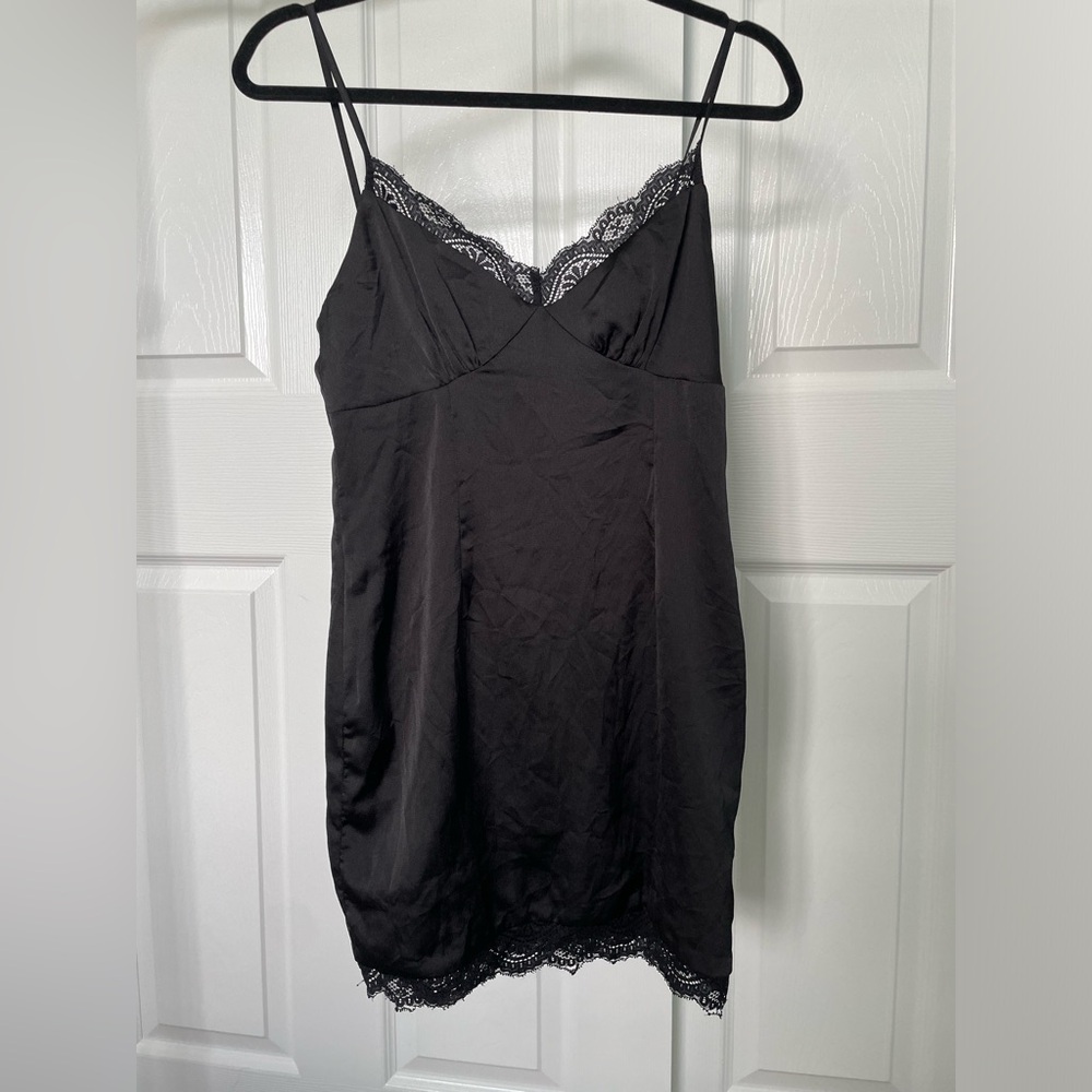 Black dress with lace detailing on the top and bottoms. Size 4.